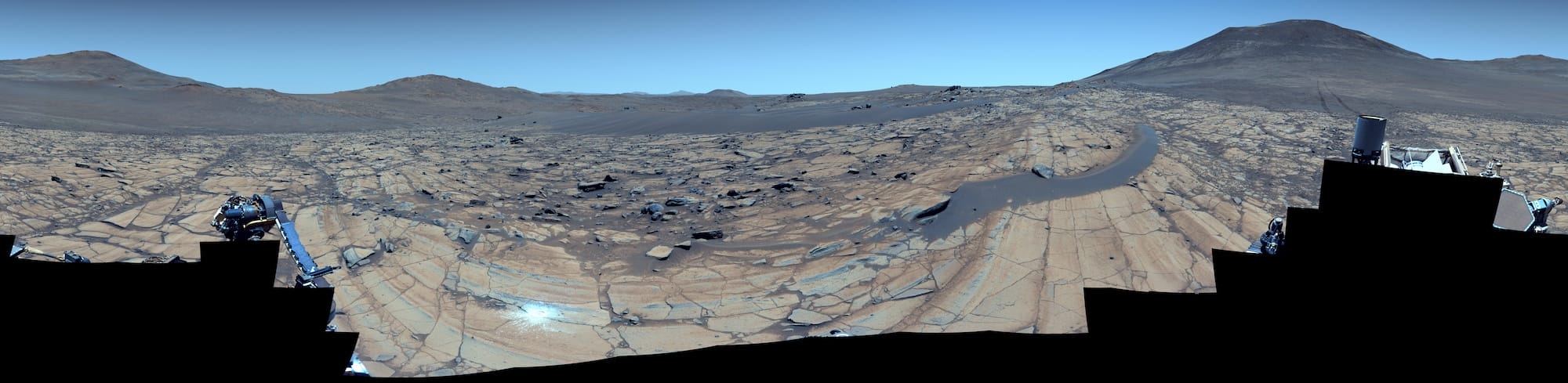 a composite color-enhanced photo of a Martian landscape that makes the red planet look more Earth-like