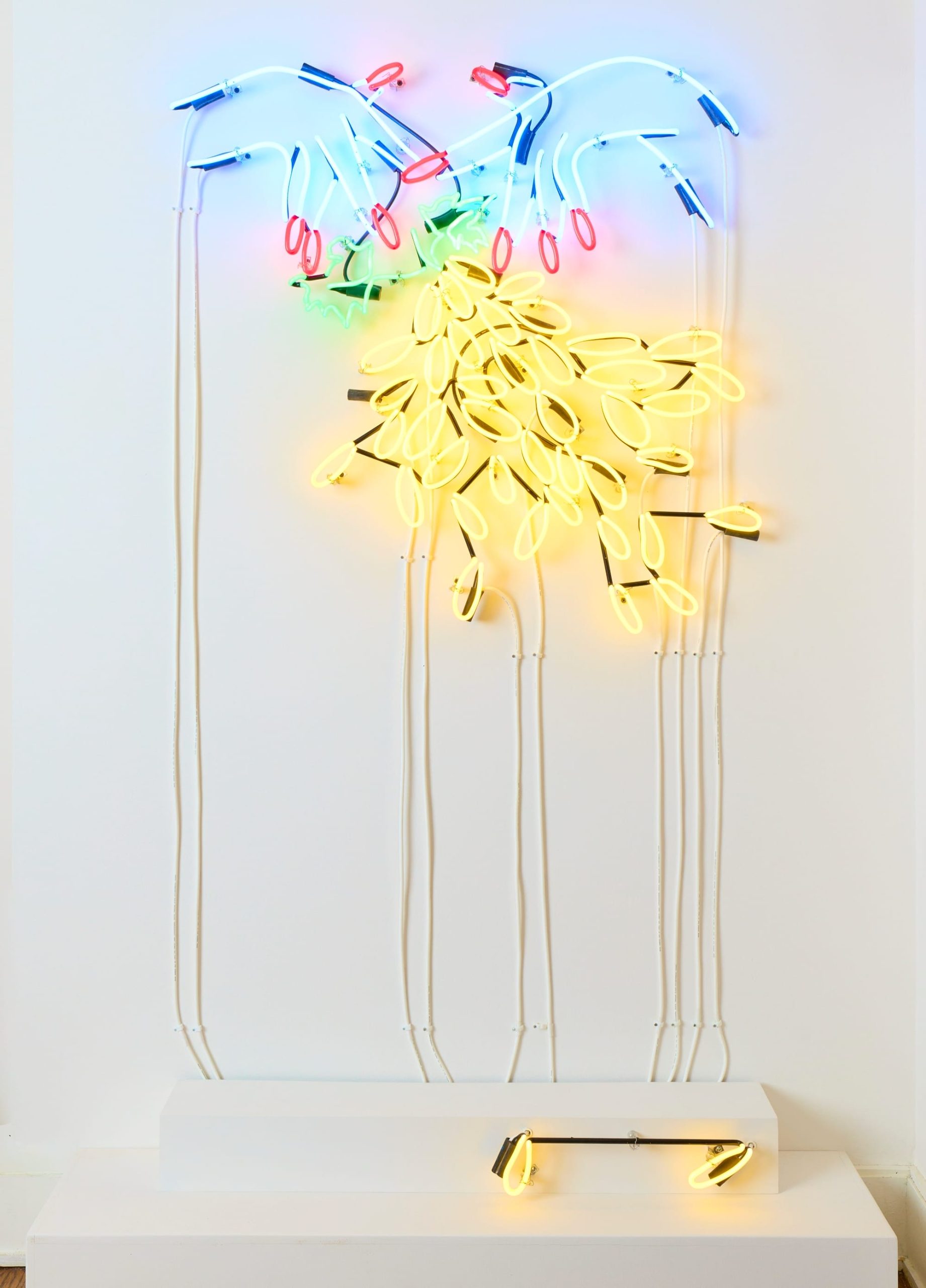 a neon work by Hangama Amiri showing hands and yellow droplets