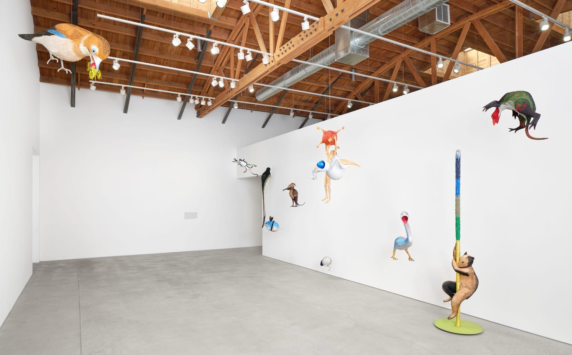 an installation view of numerous paper sculptures by Roberto Benavidez in a gallery