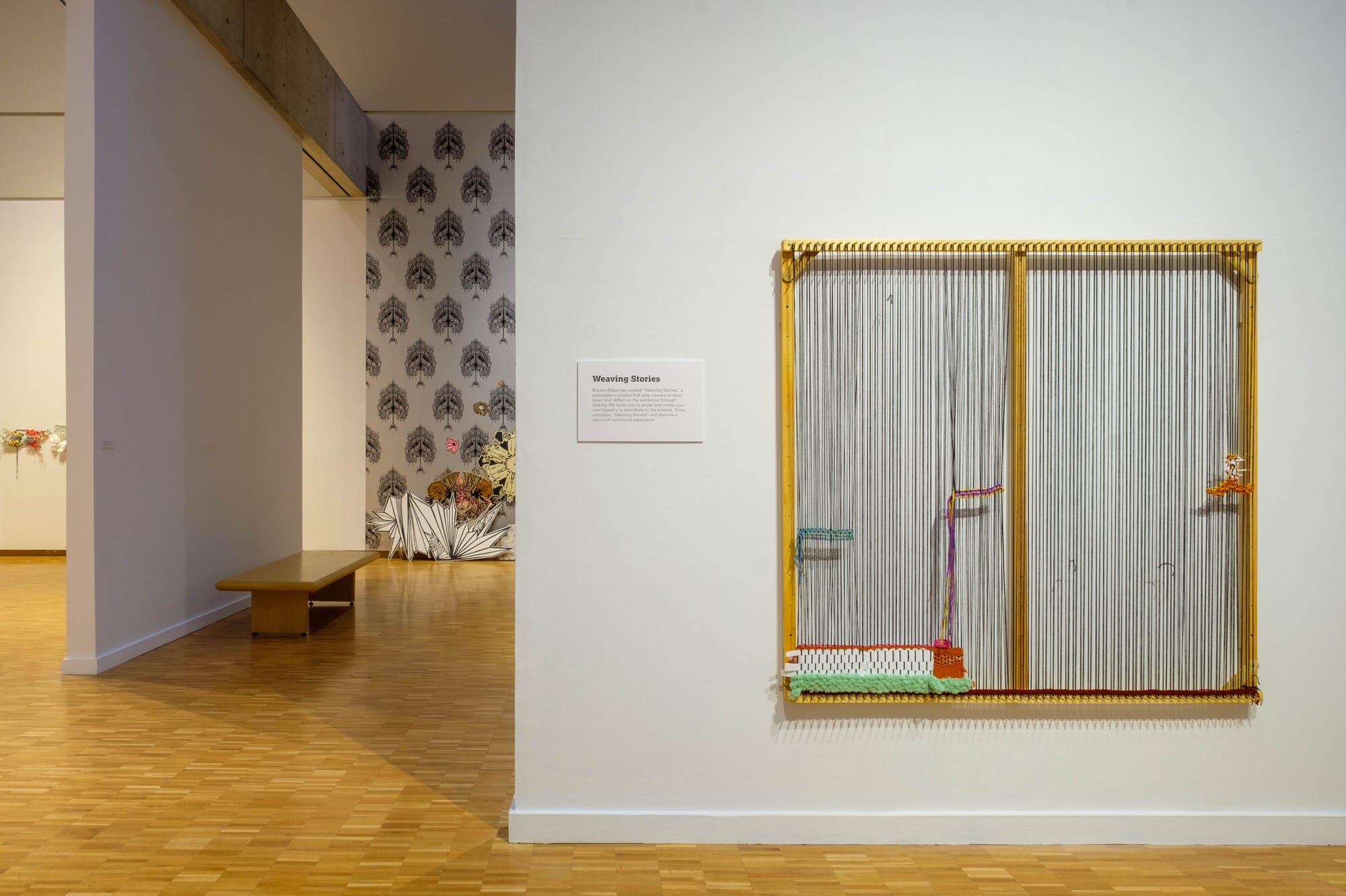 a large loom with small weavings on a gallery wall at the Haggerty Museum of Art