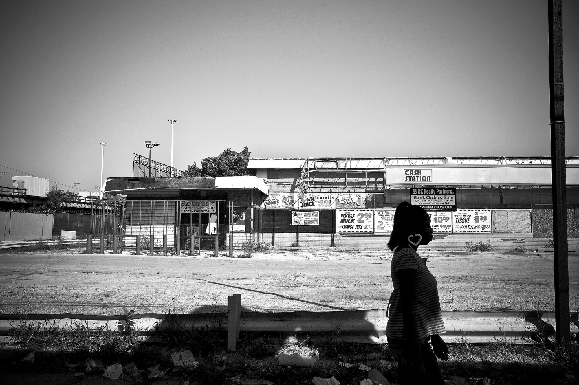 A black-and-white photograph by Carlos Javier Ortiz of dated grocery stores