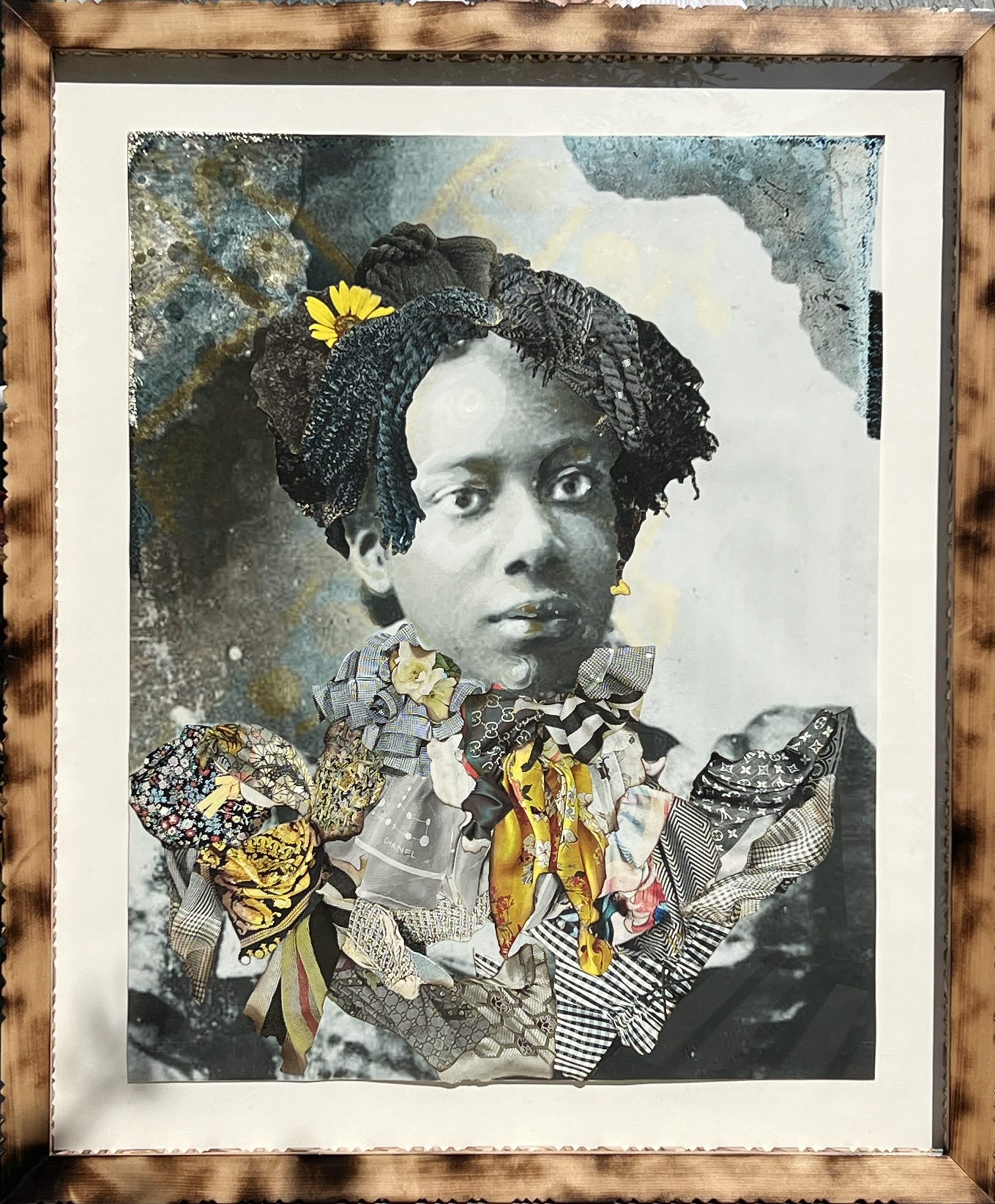 a framed portrait by Stan Squirewell, from an old photograph, of a Black woman with colorful, patterned fabrics collaged onto the image